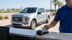 A customer hands a credit card to an agent at a car hire desk in a Texas airport