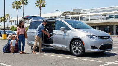 Father installing a child safety seat in the back of a family car hire vehicle in sunny Orlando
