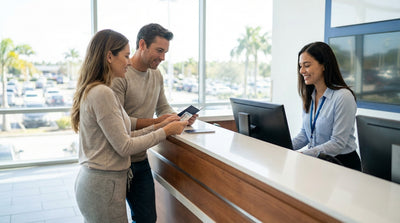 A person driving a car rental down a scenic coastal highway in the United Estates at sunset