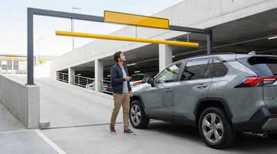 A low clearance sign shows a 6'6" height limit for a car rental entering a parking garage in Los Angeles