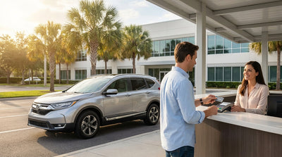 A customer hands a credit card to an agent at a car hire desk at the airport in Orlando