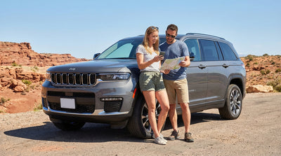 A red convertible car rental driving down the iconic Las Vegas Strip past brightly lit casinos