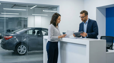 A car rental drives down a busy street in New York City with yellow cabs and tall buildings
