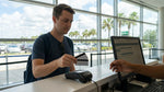 Traveler handing a credit card to a staff member at an Orlando car hire counter