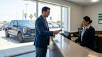 Close up of a hand passing a corporate credit card to an agent at a Texas car hire counter