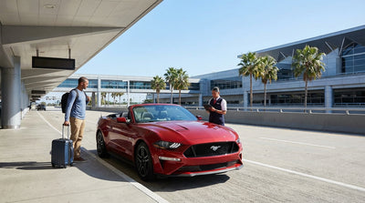 Rows of cars parked at a sunny car rental facility at the Los Angeles International Airport