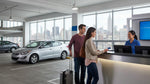 Close up of a person handing a credit card to a car hire agent at a service desk in New York