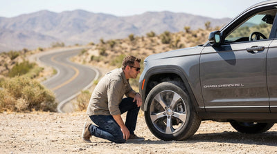 A car rental descends a scenic mountain highway with a view over the desert valley near Las Vegas