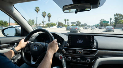 Driver's view from a car rental on a busy Los Angeles freeway with multiple lanes of traffic