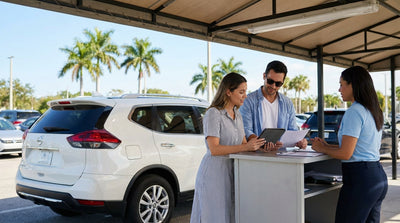 A convertible car rental driving down a sunny, palm-lined coastal highway in Florida