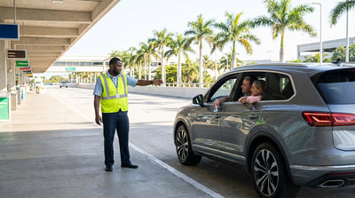 Cars lined up in multiple lanes at the sunny car rental return center at Miami airport