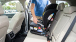 Parent securing a child car seat in the back of a Florida car hire vehicle