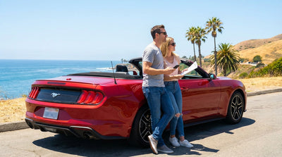 A red convertible car hire driving along the sunny Pacific Coast Highway in California