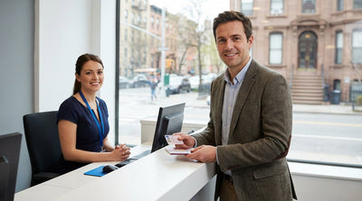 A modern car rental driving on a New York City street with yellow taxis and skyscrapers in the background
