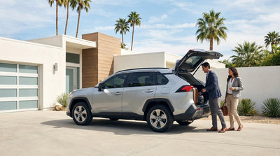 A convertible car rental driving down a winding coastal highway in Big Sur, California under a sunny sky