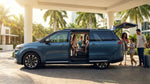 White seven-seat car rental parked along a sunny beachfront road with palm trees in Miami