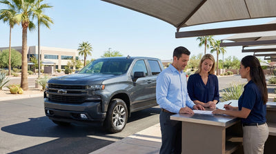 A modern car hire vehicle driving down a scenic highway under a big Texas sky