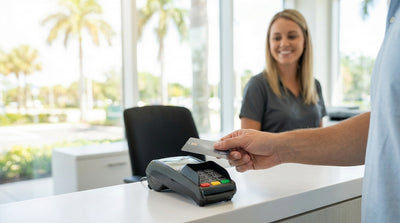 A modern car hire vehicle parked on a sunny beach in Florida with palm trees and blue ocean