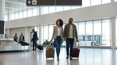 A traveler with luggage waits for the car hire shuttle bus outside the Philadelphia Airport arrivals terminal