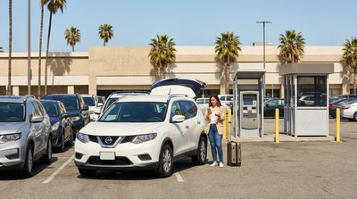 An overflowing car hire return lot in Los Angeles with vehicles parked close together on a sunny day