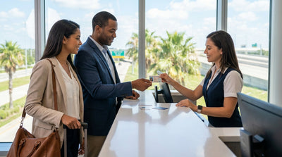 A person driving a car hire vehicle down a long, straight road through the Texas desert at sunset