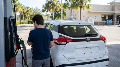 A driver refueling their car hire at a sunny gas station pump in Florida