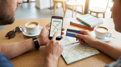 A car rental driving across the iconic Bixby Bridge on a sunny day in Big Sur, California