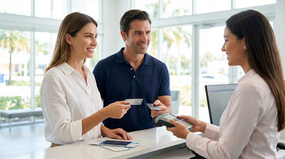 A white convertible car rental parked on a sunny Miami street lined with iconic palm trees