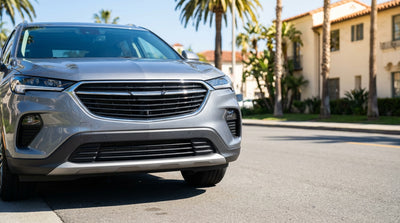 A modern car hire on a sunny California street with no front license plate on its bumper