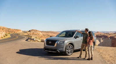 A red convertible car hire driving on a desert highway towards the mountains outside Las Vegas