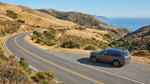 A red convertible car hire driving across the Golden Gate Bridge in San Francisco on a sunny day