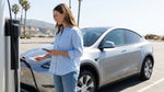 Hand tapping an RFID card on a charging station next to an electric car rental in sunny California