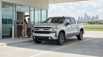 A car hire driving down a long, open road through the Texas landscape at sunset