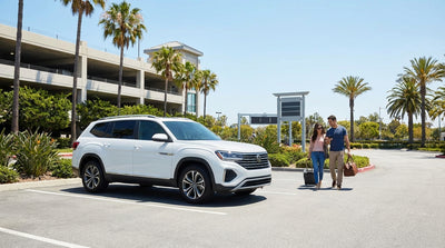A modern car hire vehicle parked under sunny skies and palm trees in a Disney Springs lot in Orlando