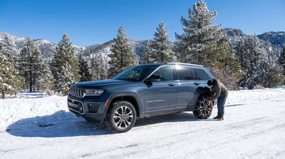 A car hire drives on a snowy, winding mountain road on Mount Charleston near Las Vegas in winter