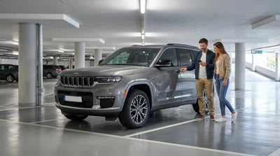 A car hire parked on the San Francisco waterfront with Alcatraz Island visible in the bay