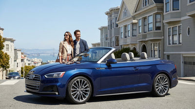 A luxury Audi car rental parked with a view of the Golden Gate Bridge in San Francisco
