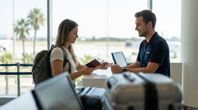A convertible car hire driving down a sunny coastal road lined with palm trees in Florida