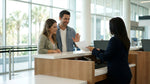 A customer speaks with an agent at a car hire counter inside the Orlando airport terminal
