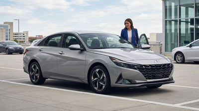 A modern car rental driving through a bustling New York street scene with yellow taxi cabs