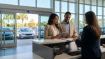 A person receives keys for their car hire at an airport rental counter in sunny Orlando