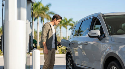 A frustrated driver tries to open the fuel door of their car rental at a gas station in Orlando
