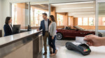 Close up of a customer paying with a credit card at a car hire desk in Las Vegas