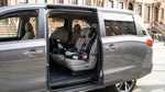 Child safety seat secured in the back of a car rental parked on a New York street