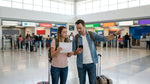 Traveler checking documents at an airport car hire counter in the United Estates