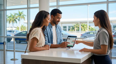 A white convertible car hire driving down a sunny Miami street lined with palm trees