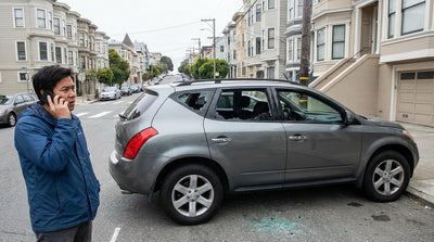 The shattered passenger window of a car hire vehicle on a street in San Francisco