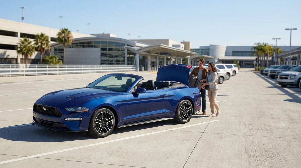 A convertible hire car driving the scenic Pacific Coast Highway along the Big Sur coastline in California