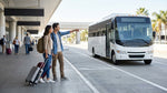 A row of car hire shuttle buses waiting for travelers outside the Orlando Airport terminal