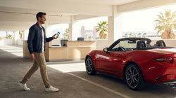 A traveler receiving keys from an agent at a car rental desk in Las Vegas